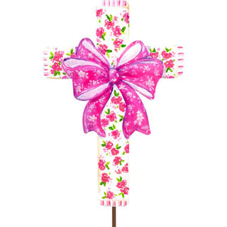 Decorative cross with pink floral pattern and a large pink bow on a white background