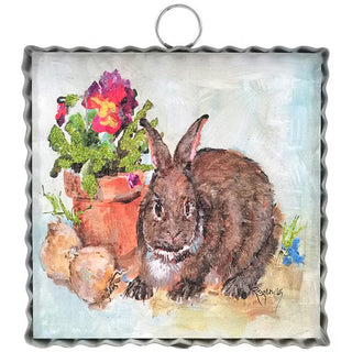 Decorative metal sign with a rabbit and potted plants illustration on a textured background