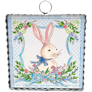 Decorative panel with a rabbit illustration surrounded by flowers and leaves on a checkered background.