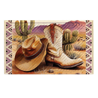 Cowboy hat and boots with a desert landscape background