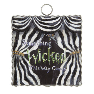 Halloween decorative charm and text 'Something Wicked This Way Comes'