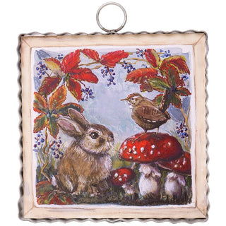 Charm that has bunnies and mushrooms with turning leaves