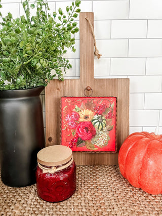 Decorative red charm with colorful flowers and berries