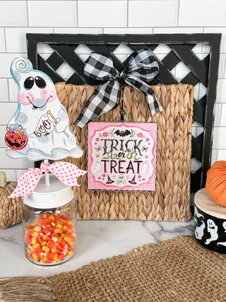 'Trick or Treat' text on a pink checkered Halloween-themed decorative charm