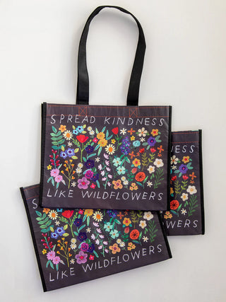 Black reusable bag with wildflowers and the saying 'spread kindness like wildflowers'