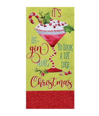 A rectangular decorative sign or print with a Christmas-themed cocktail illustration and the phrase “It’s Be Ginning To Look A Lot Like Christmas.” The design has a light yellow-green background, a red patterned band at the bottom, and festive accents including candy canes, holly, and whipped cream.
