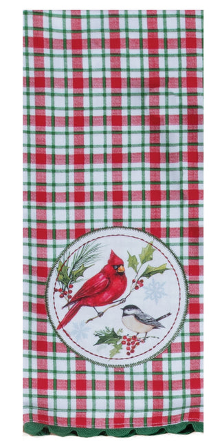 A red, green, and white plaid kitchen towel with a circular holiday bird design in the center featuring a cardinal and a chickadee.