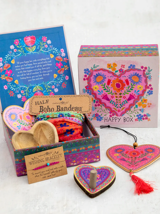 Colorful gift box with heart designs and wooden items on a white background