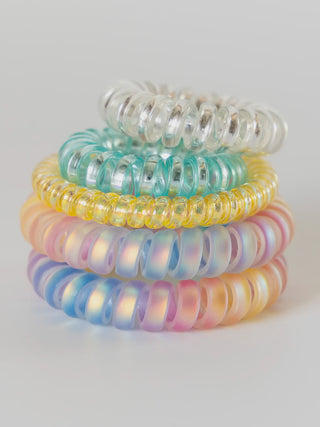 Stack of pastel-colored hair ties on a white background