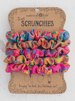 Colorful scrunchies on a Natural Life branded card