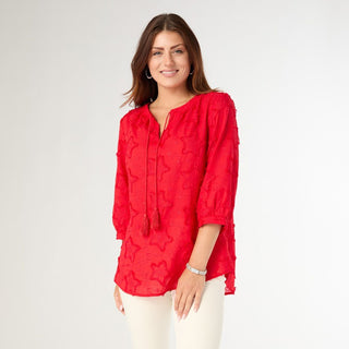 Woman wearing a red blouse with a white background
