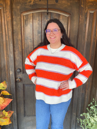Crewneck sweater with orange, purple, and white stripes