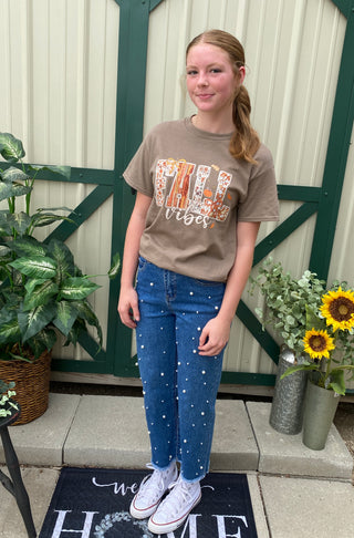 Blue jeans with pearls distributed on the front
