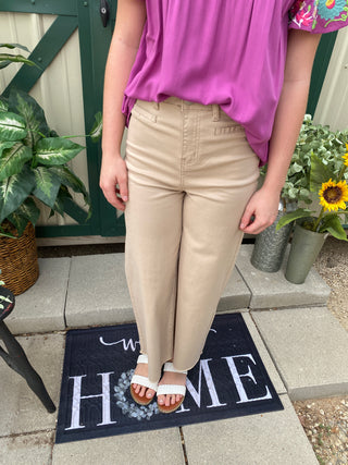 High waisted tan jeans with slender pockets