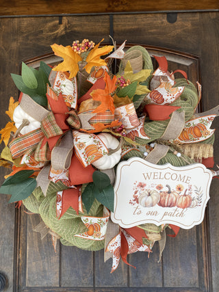 Decorative wreath with autumnal elements and a 'Welcome to our patch' sign 