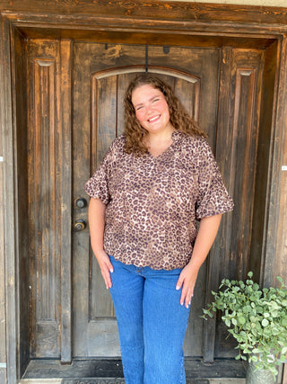 Leopard print blouse with puff sleeves and scalloped hem