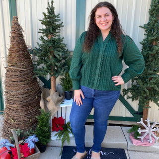 Green button up blouse with ruffle details and cuffed sleeves