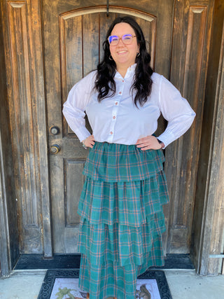 Make spirits bright with the Renee Long Sleeve Top — a crisp, classic blouse with a subtle holiday twist. Designed for the season’s many moments, this timeless white button-down features delicate red buttons and elegant smocking at the cuffs for a touch of seasonal charm