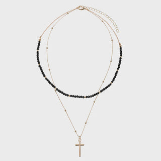 Two layered necklaces with black beads and a gold cross pendant
