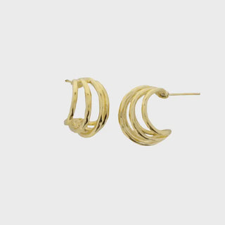 Gold hoop earrings on a light gray background