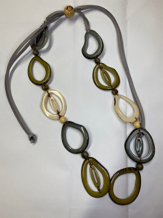 Necklace with green, gold, and gray abstract pendant on a white background