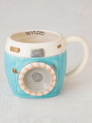 Camera-shaped mug with turquoise body and white top 