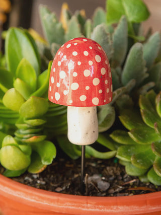 Decorative mushroom with a red cap and white polka dots key hiding place