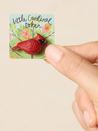 Small red cardinal figurine on a card 