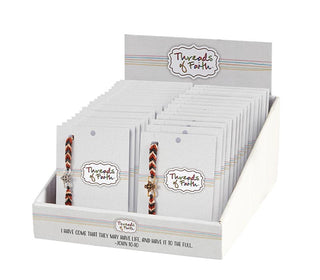 Display of 'Threads of Faith' bracelets in packaging on a white background
