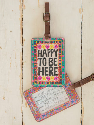 Colorful luggage tag with 'Happy Be Here' text 