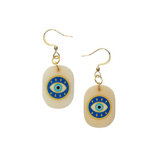 Pair of earrings with eye design on beige stones against a white background
