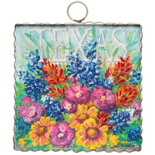 Decorative sign with colorful flowers and 'TEXAS' text on a white background