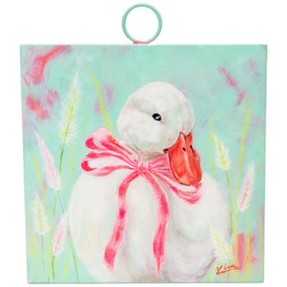 a white duck with a pink bow tied around its neck 