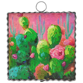 Decorative plate with a colorful cactus design on a pink background
