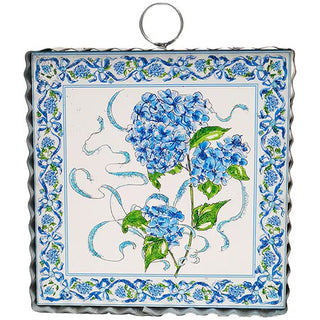 Decorative tile with blue floral design on a white background