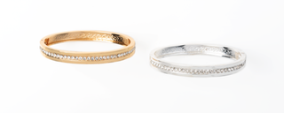Two gold and silver bracelets on a white background
