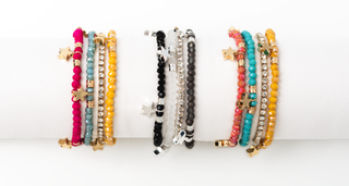 Set of colorful beaded bracelets on a white background