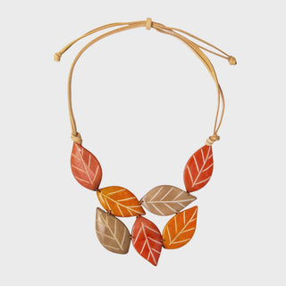 Necklace with leaf-shaped beads in orange, brown, and beige on a light gray background