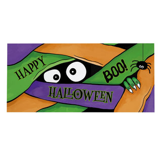 A colorful Halloween-themed graphic or print featuring a cartoon monster peeking from behind green, purple, and orange fabric. The fabric has the words 'HAPPY HALLOWEEN' and 'BOO!' printed on it, with a black spider on a web on the right side.