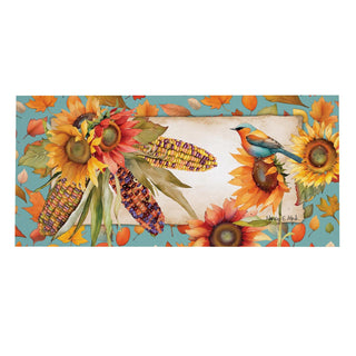 A rectangular autumn-themed art print featuring sunflowers, corn ears, falling leaves, and a small bluebird on a turquoise background, with a blank cream-colored banner in the center.