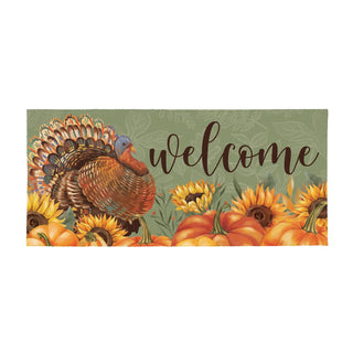 Decorative mat with a turkey, sunflowers, and pumpkins on a green background with 'welcome' text.