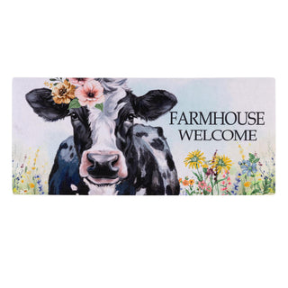 Doormat with cow illustration and 'Farmhouse Welcome' text on a white background