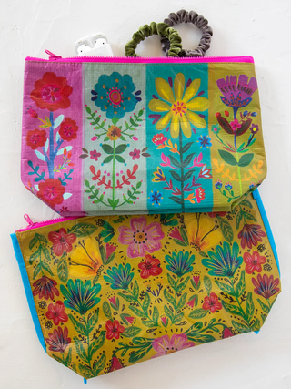 Colorful floral-patterned pouches on a white background