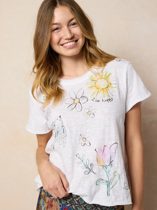 Young woman wearing a white t-shirt with colorful floral designs on a beige background