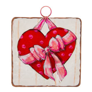 Heart-shaped Round Top Charm with a pink bow on a white background