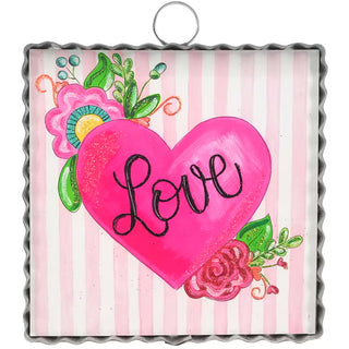 Decorative wall art with a pink heart and 'Love' text on a striped background
