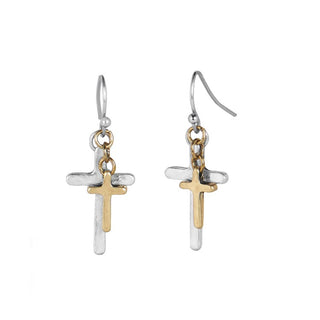 Pair of cross-shaped earrings in gold and silver on a white background