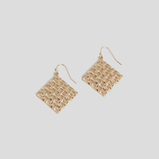 Gold woven square earrings on a light gray background