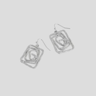 Pair of silver square-shaped earrings on a light gray background