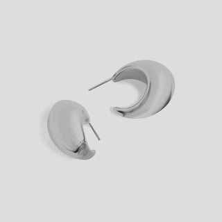 Pair of silver hoop earrings on a light gray background